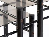 a glass table with black metal legs and a glass top