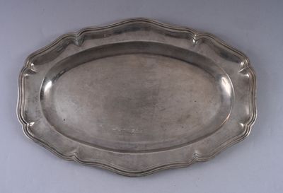 an antique silver plate on a white table with a white background