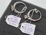 two rings with tags attached to them on a black cloth