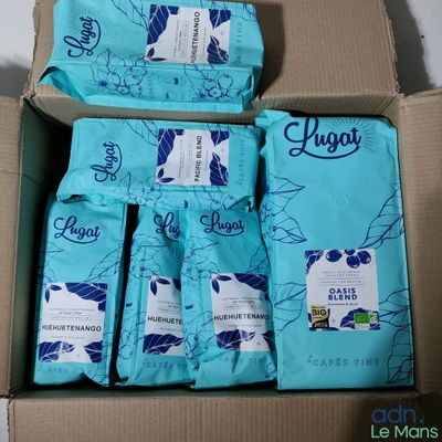 five bags of coffee in a box on a table