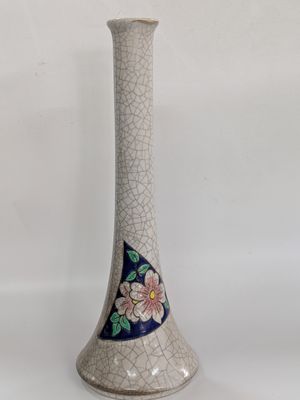 a white vase with a blue and white design on it