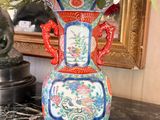 a vase with flowers in it sitting on a table