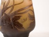 a glass vase with a design on it sitting on a table