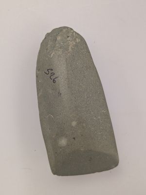 a close up of a rock with writing on it on a white surface