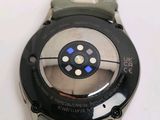 a close up of a watch on a white surface