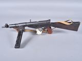 an old toy gun with a wooden handle on a white surface