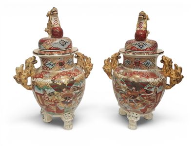 pair of chinese vases with dragon handles on stands on a white surface