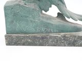 a statue of a bird that is sitting on top of a rock