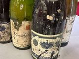 several bottles of wine are lined up on a table