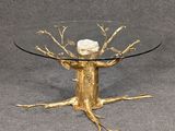 an image of a glass table with a gold tree on it