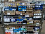 a metal cart with many boxes on top of it