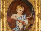 portrait of a young boy in a blue striped dress holding a toy
