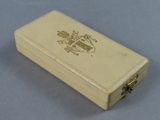 a small wooden box with a coat of arms on it