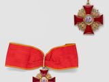 an image of a red ribbon with a gold cross and a red ribbon with a gold cross on it
