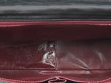 the inside of a black purse with a red lining