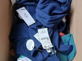 a cardboard box filled with clothing and a pair of shoes