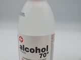 a bottle of alcohol sitting on a table next to a bottle of liquid