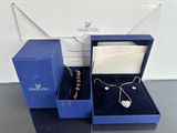 a blue box with a necklace and earring in it
