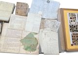 a lot of old papers and other items in a wooden box