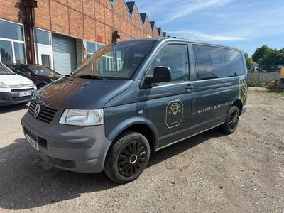 the van is parked in front of a brick building