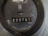 a close up of a clock on the side of a machine