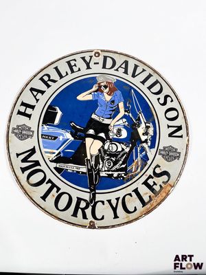 a sign that says harley davidson motorcycles on the side of a building