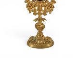 an image of a gold plate with a clock on top of it