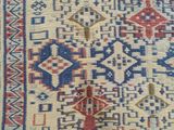a close up of a rug with a red and blue design on it