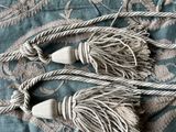 two tassels that are laying on a bed