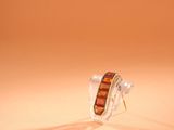 a close up of a pair of earrings sitting on top of a table