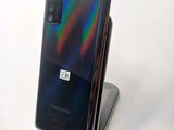 the back of a samsung galaxy note 10 lite with a phone on a stand