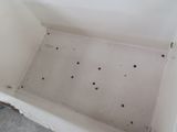 a dirty bathtub with holes in it on the floor