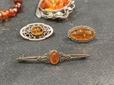 three pieces of jewelry sitting on top of a table next to each other