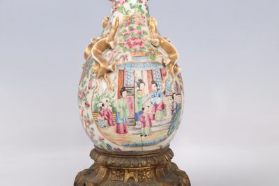 a vase with a painting on it sitting on a stand