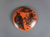un bouton orange sur lequel figurent l'image d'une pieuvre et une pieuvre