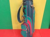 a picture of a blue and red golf bag on a red floor