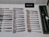 many forks and spoons in a case on a table