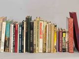 many books that are lined up on a shelf