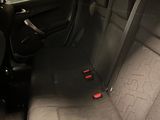 the back seats of a car are empty in a parking lot