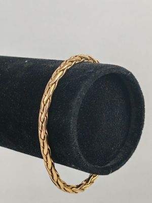 a close up of a gold ring on a black ring holder