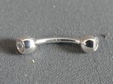 a silver belly ring with two hearts on it