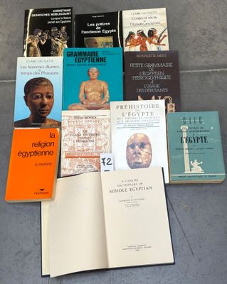 several books are sitting on the floor next to each other