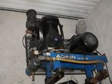 two air compressors sitting on top of a blue machine