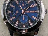the watch is on the wrist of a man with a blue face