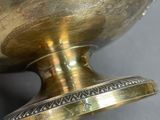 a close up of a gold vase on a table