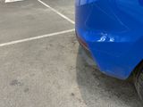 a blue car that is parked in a parking lot