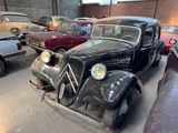 many old cars parked in a parking lot together