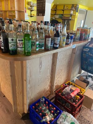 many bottles of alcohol sitting on the counter in the store