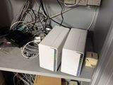a shelf that has a lot of wires and other electronics on it