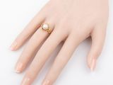 a close up of a person ' s hand with a ring on it